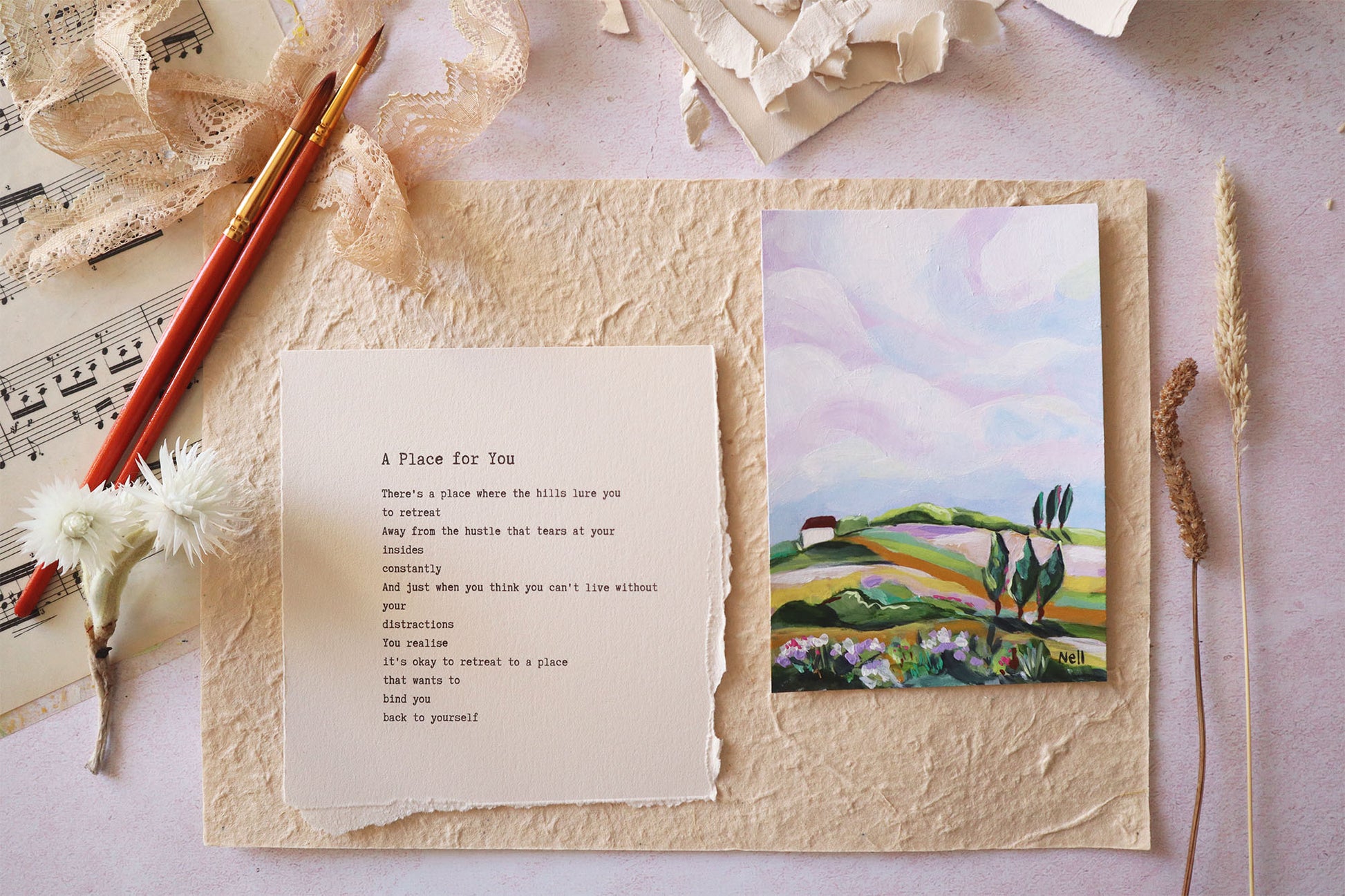 Sheet of paper with text and a painting of a landscape on a textured surface.