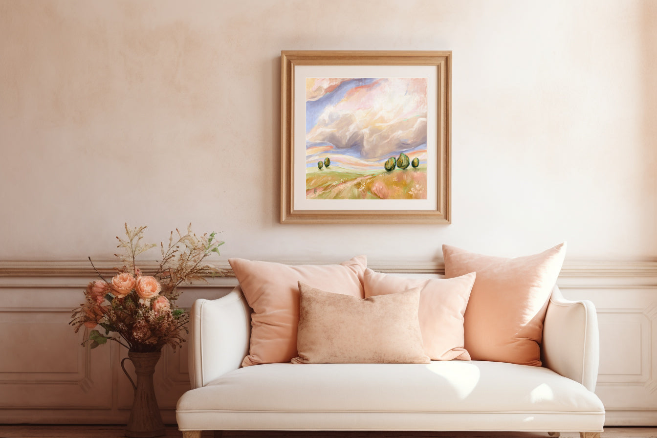 Living room with a white sofa, pink pillows, and a framed painting on the wall.
