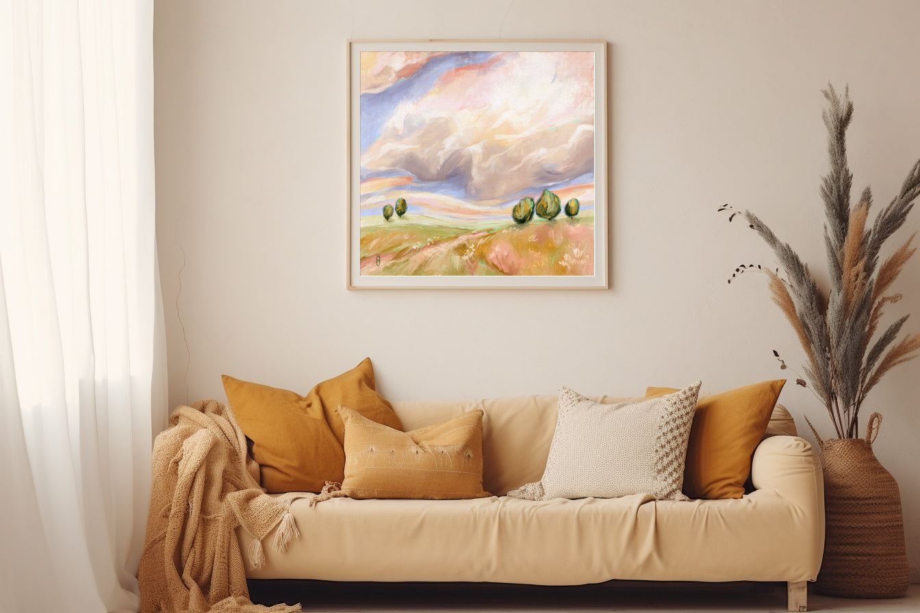 Living room with beige sofa, decorative pillows, and a framed landscape painting on the wall.