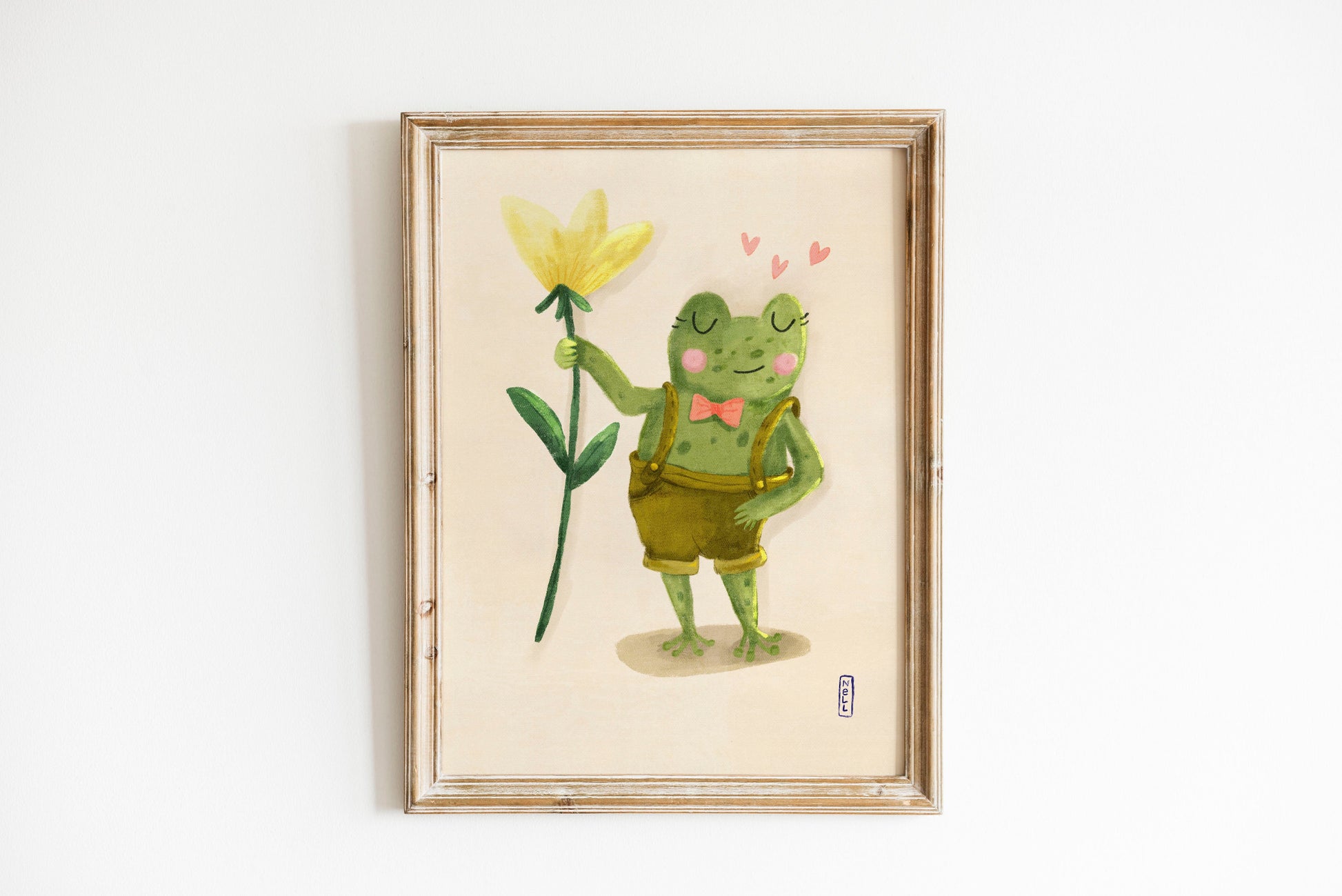 Framed artwork of a cartoon frog holding a yellow flower on a white background