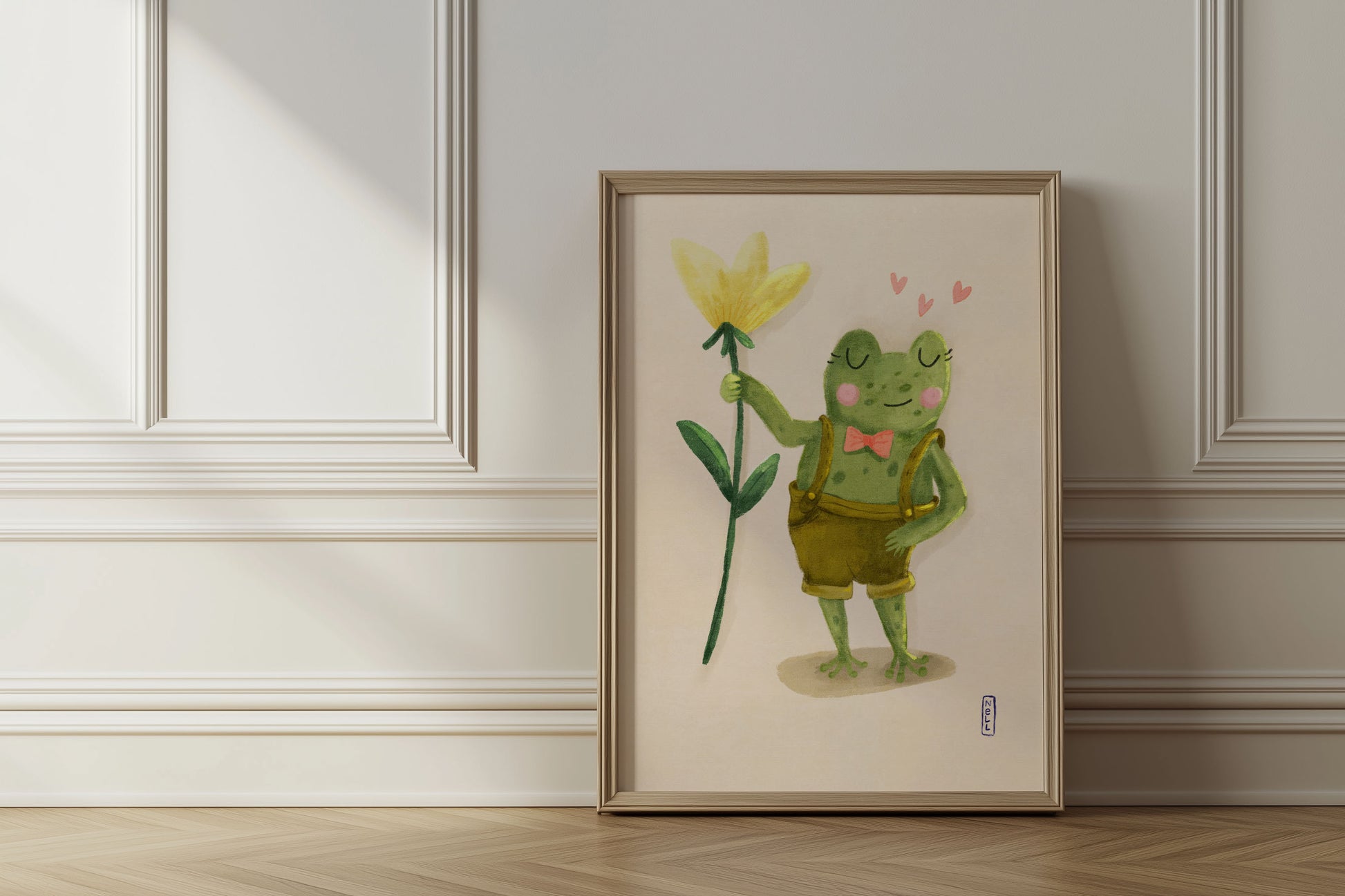 Framed artwork of a frog holding a flower on a wall.