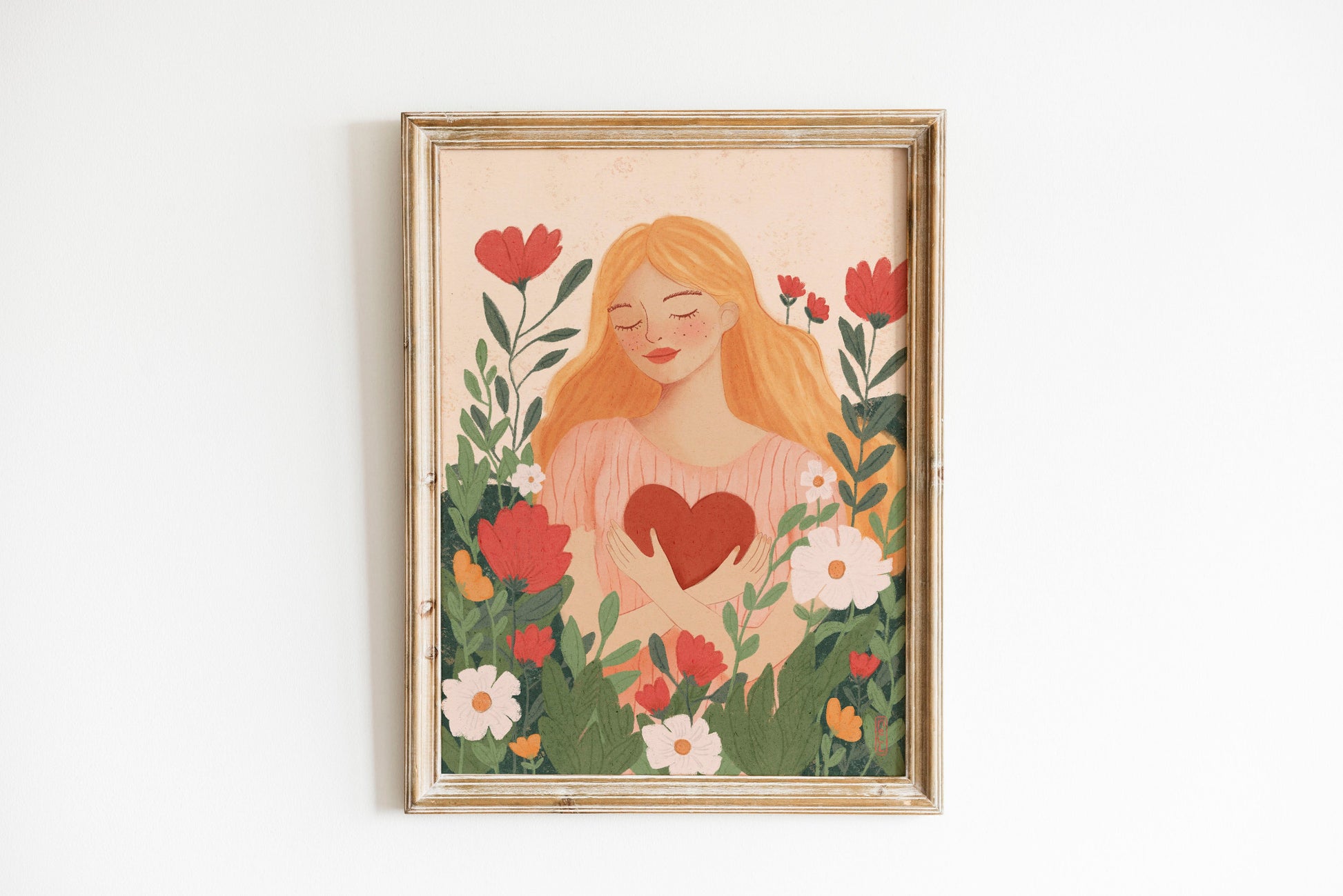 Framed artwork of a woman with a heart surrounded by flowers on a white background