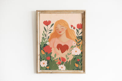 Framed artwork of a woman with a heart surrounded by flowers on a white background