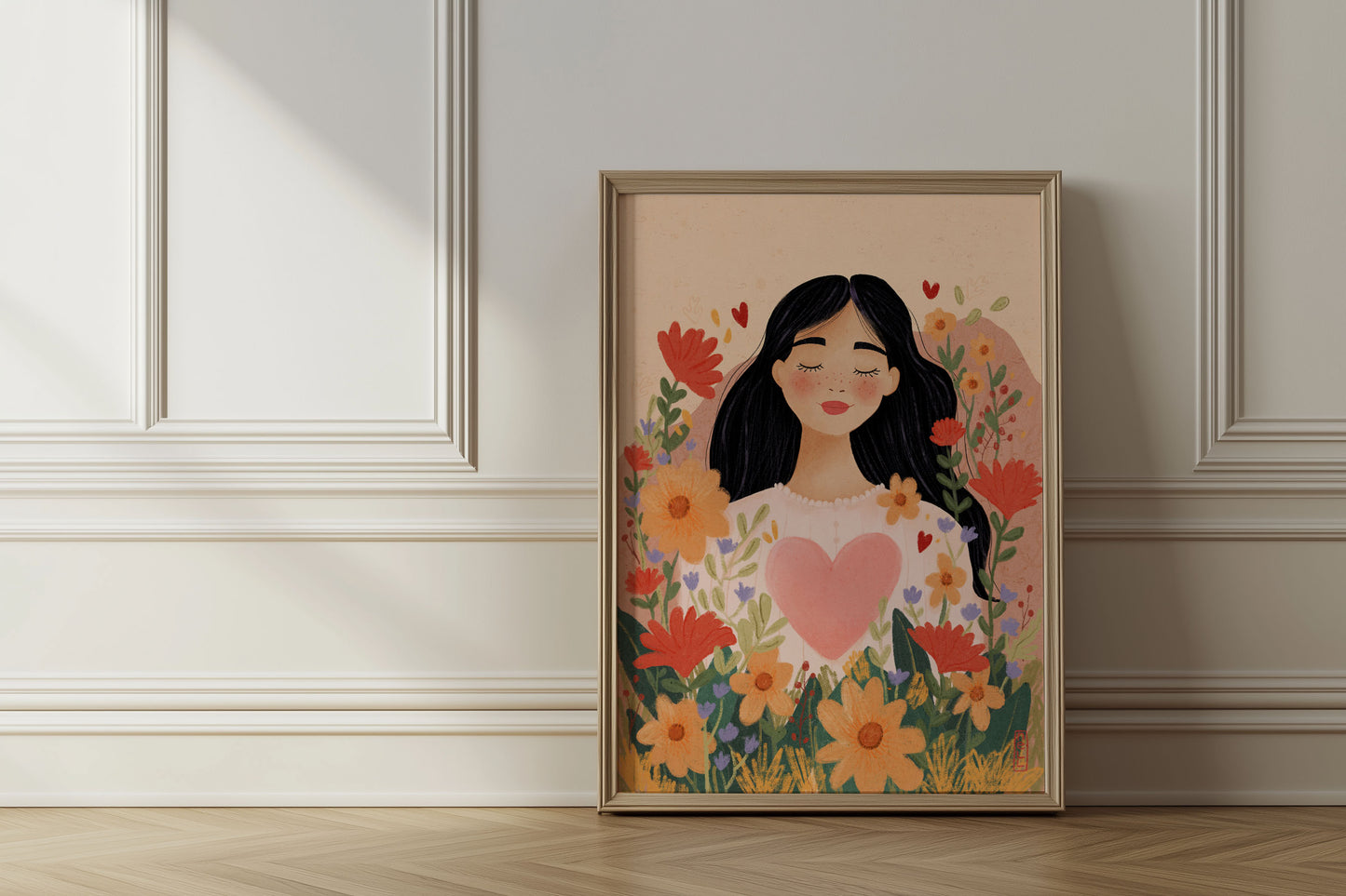 Framed artwork of a woman with flowers and a heart on a wall.