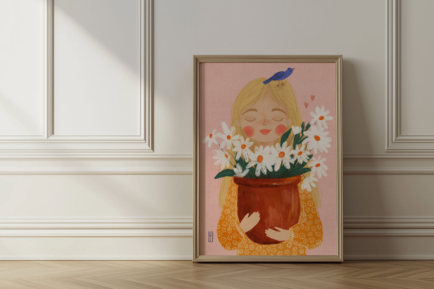 Framed artwork of a girl holding flowers against a light wall.