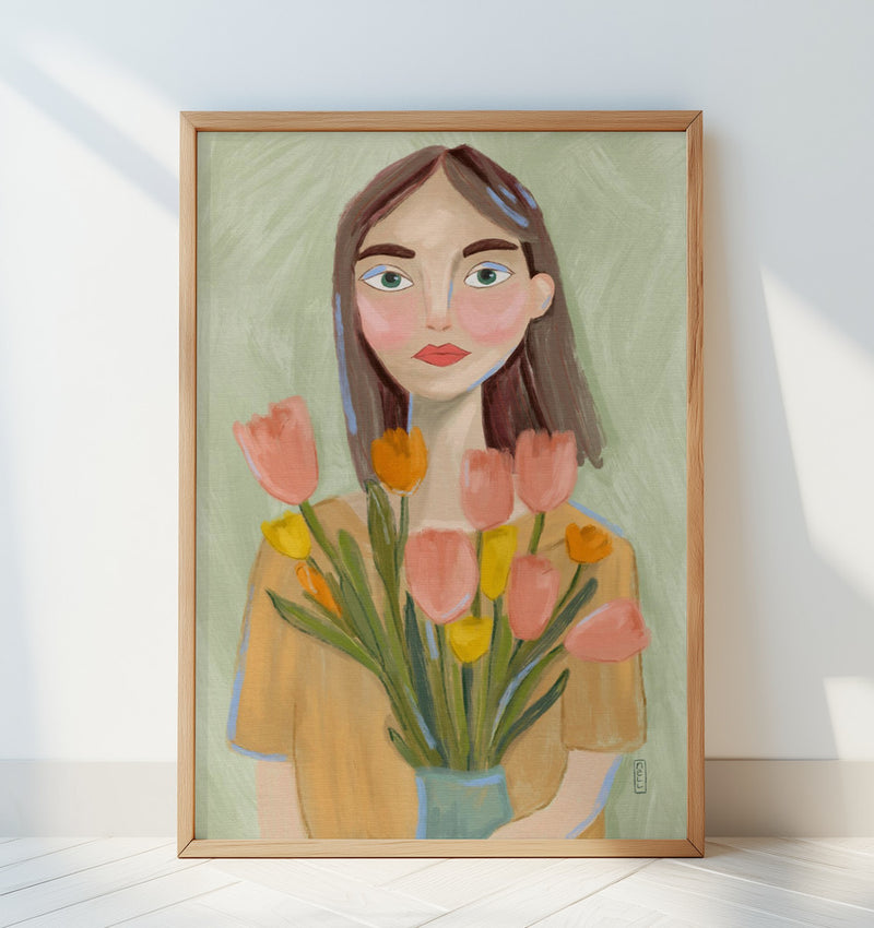 Framed artwork of a woman holding flowers on a white surface