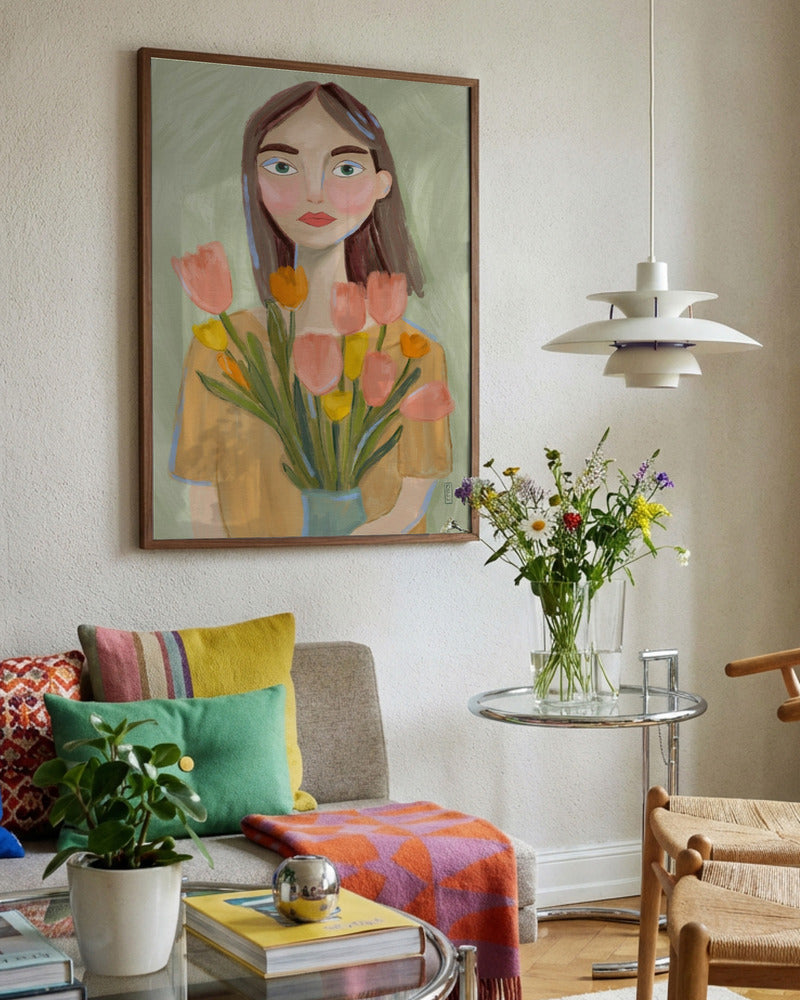 Living room with colorful decor, including a painting of a woman holding tulips and a lamp.