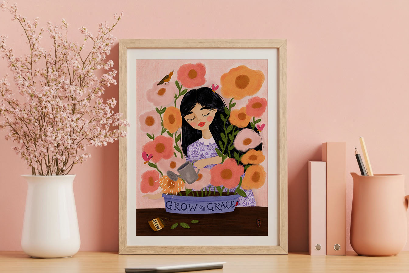 Framed artwork of a woman with flowers on a pink wall