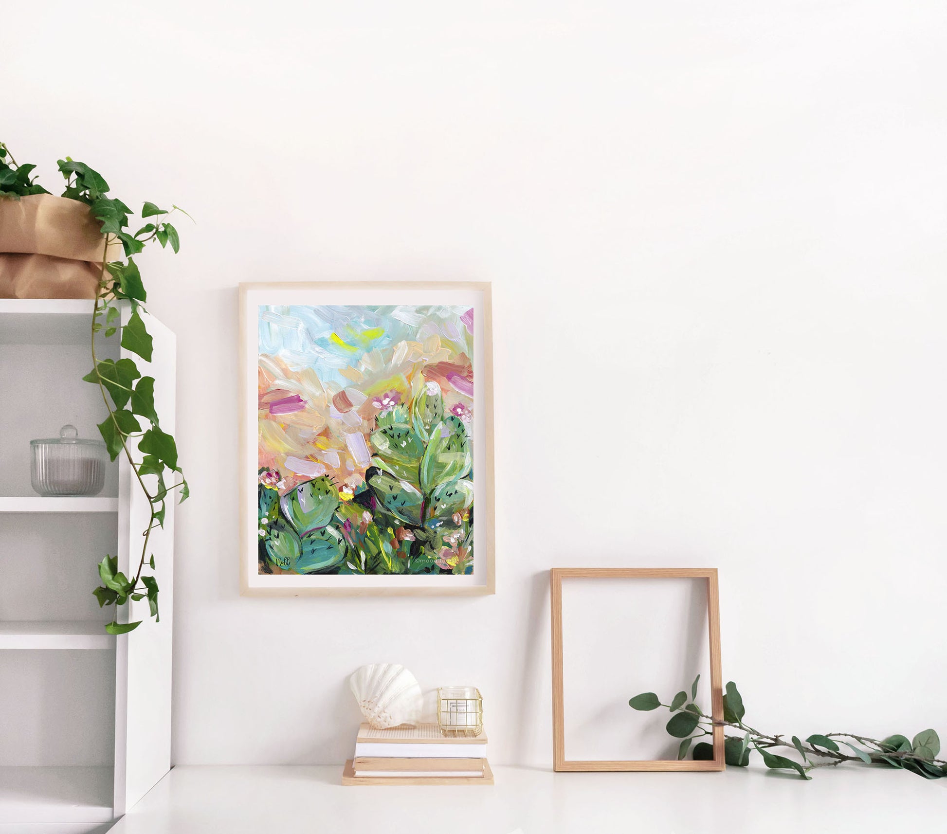Framed abstract art piece on a white wall with decorative elements.