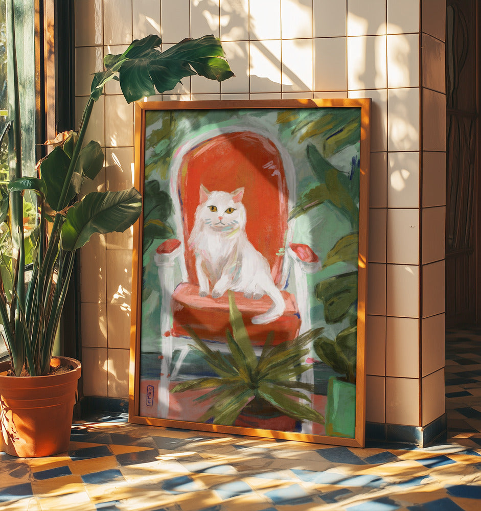 Framed artwork of a white cat on a red chair with plants and sunlight in the background