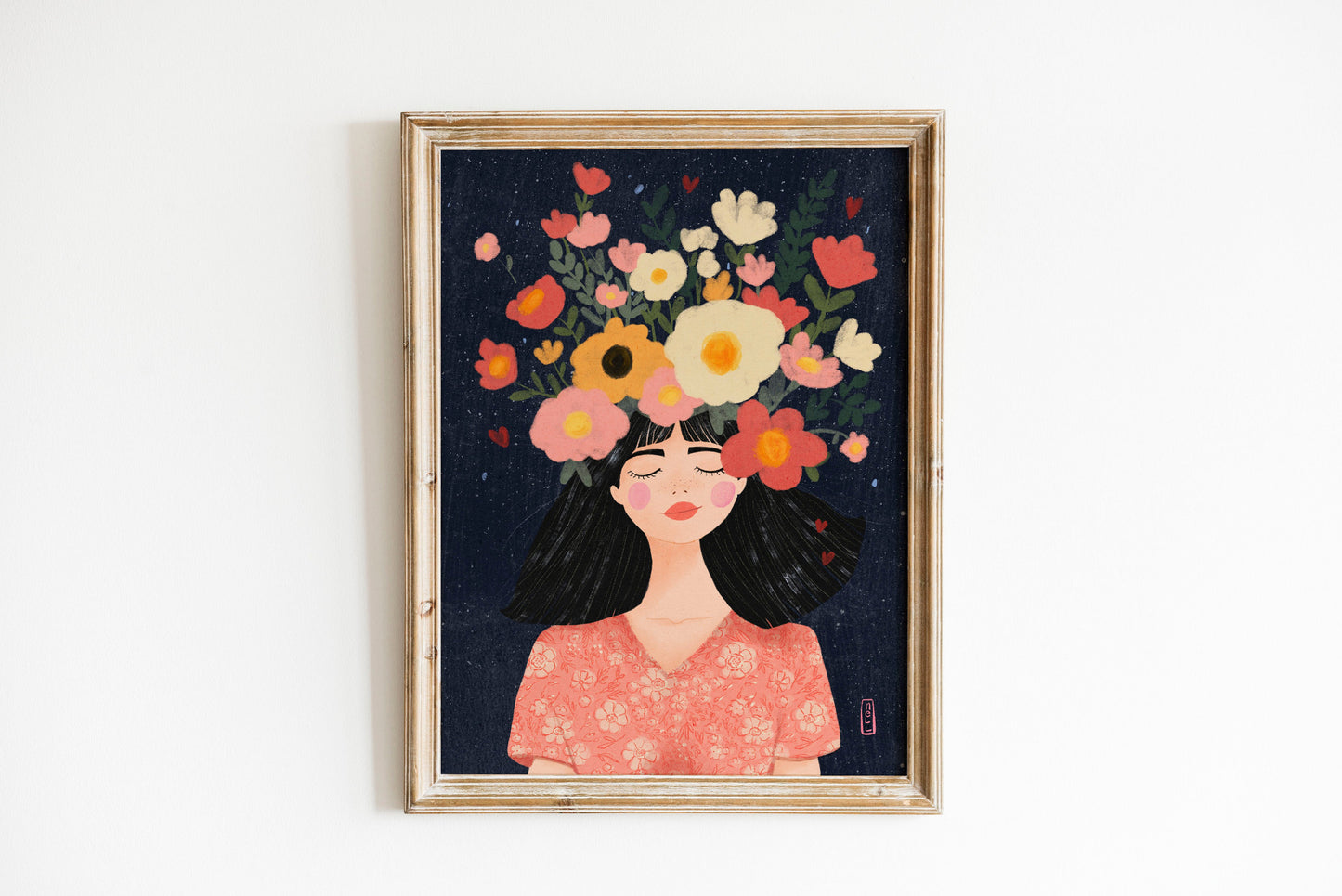 Framed artwork of a woman with flowers on her head against a dark background