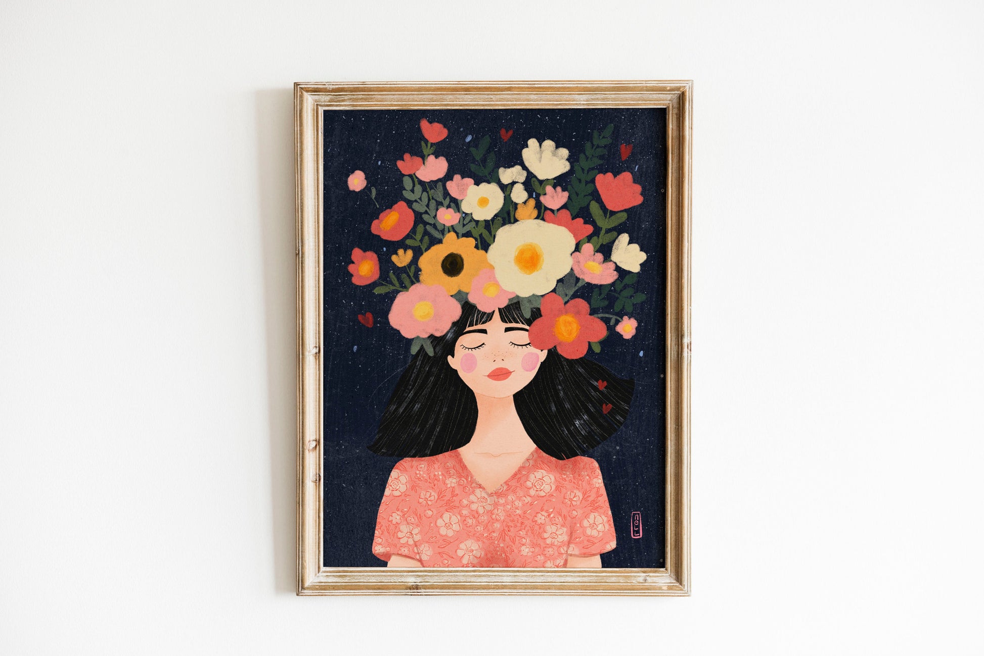 Framed artwork of a woman with flowers on her head against a dark background