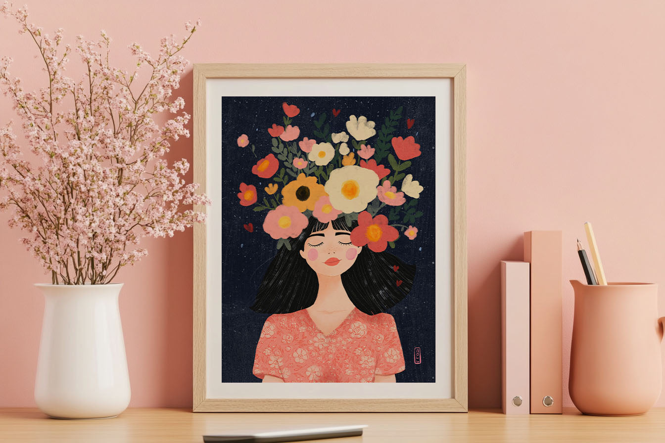 Framed artwork of a woman with flowers on her head on a desk with decorative items.