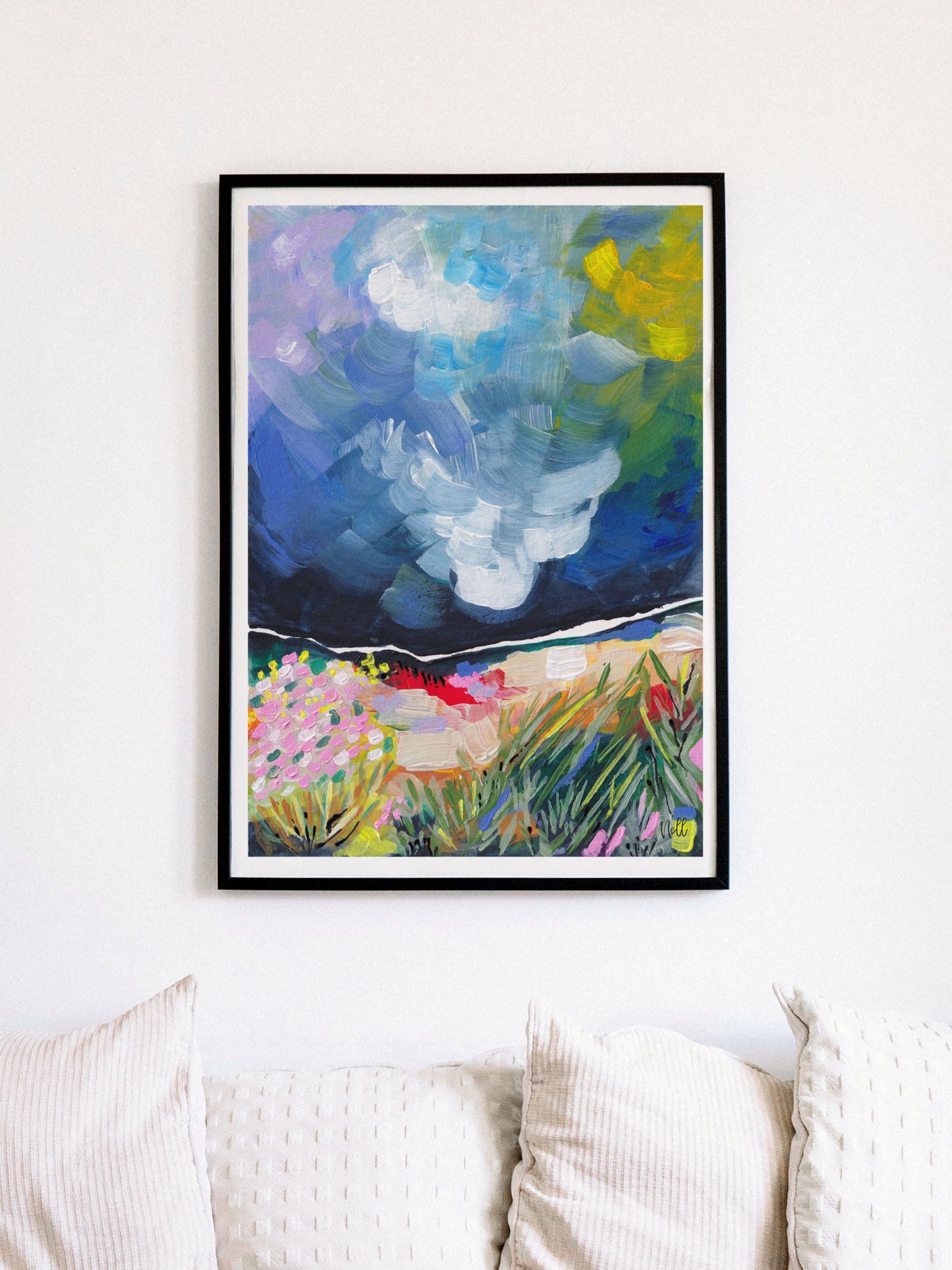 Framed abstract painting on a wall above a sofa