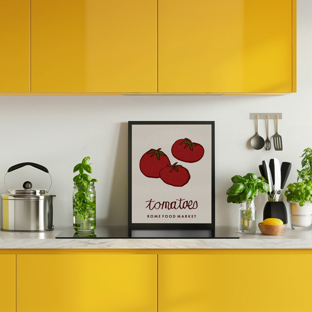 Kitchen with yellow cabinets, a framed picture of tomatoes, and various kitchen items.